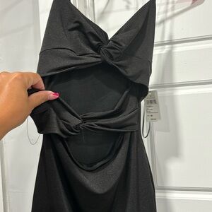 Brand new, never worn before black and short dress. Open in the front